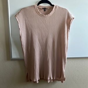 Pale pink ribbed shirt.